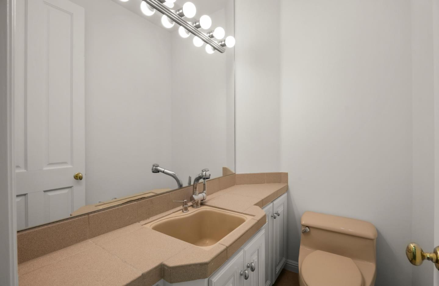 14113 Pike Road Saratoga, CA 95070 - Photo 56 of 78 a bathroom with a granite countertop toilet a sink and mirror
