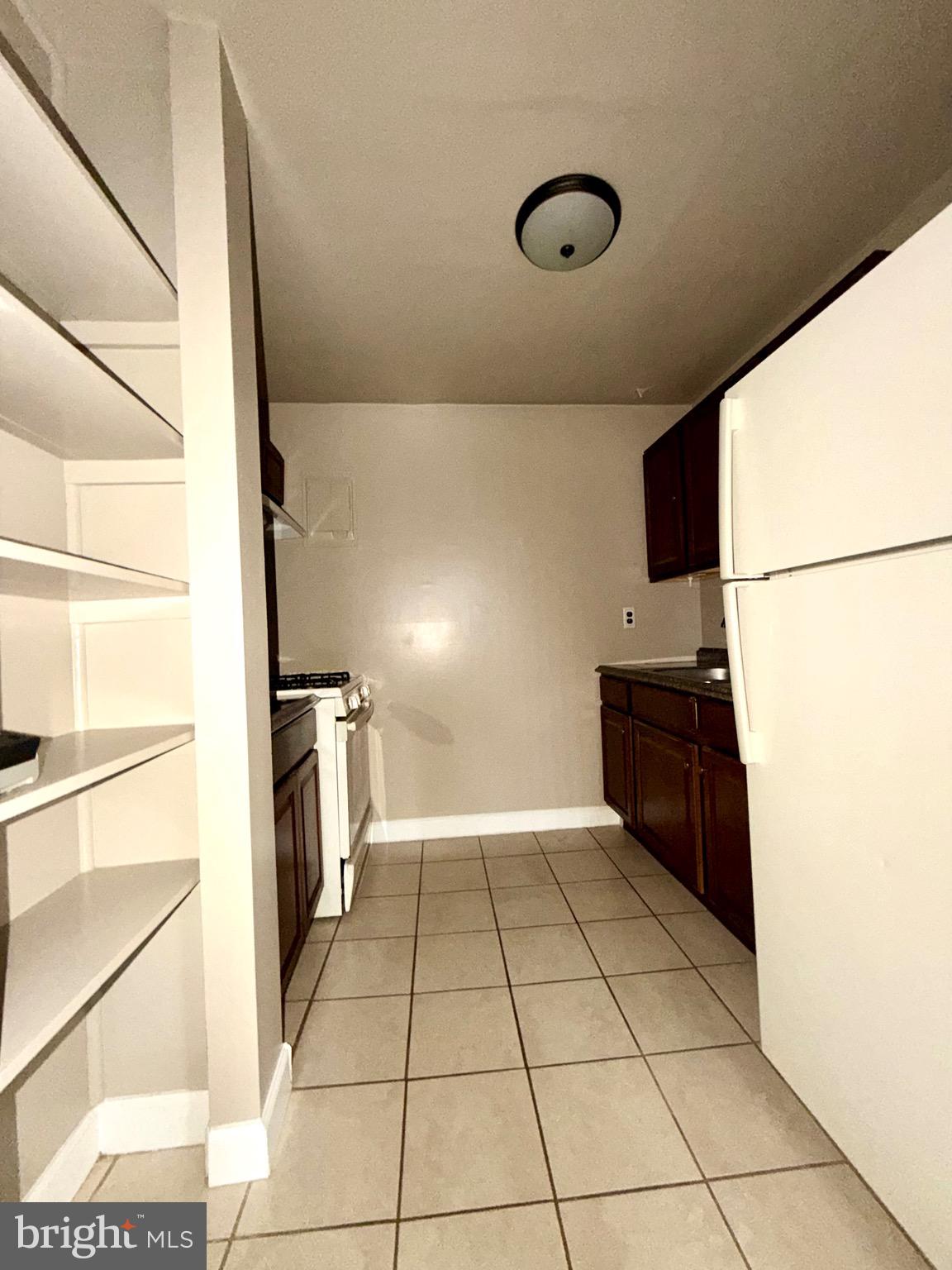 9282 Adelphi Road, Unit 303 Hyattsville, MD 20783 - Photo 6 of 16 Kitchen w/ Built-In Shelving