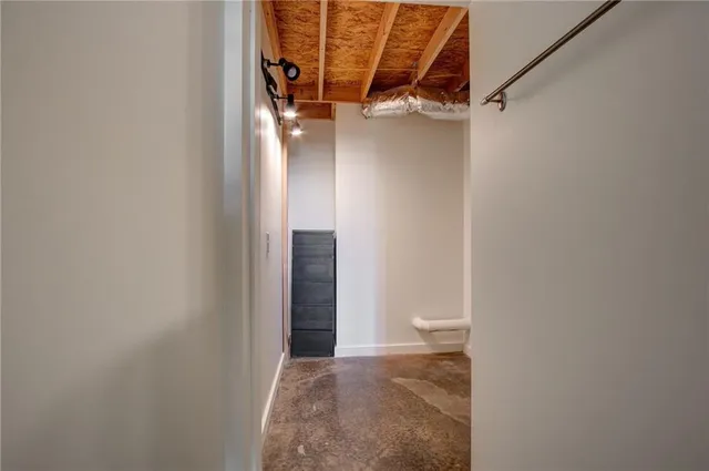 a view of walk in closet with clothes