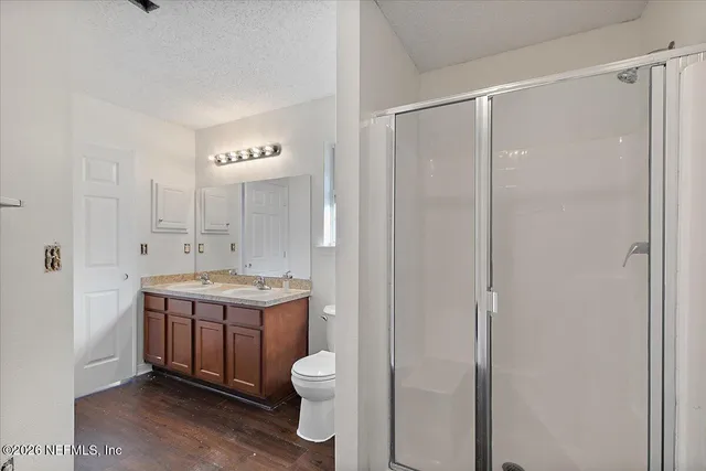 a bathroom with a granite countertop sink toilet and shower