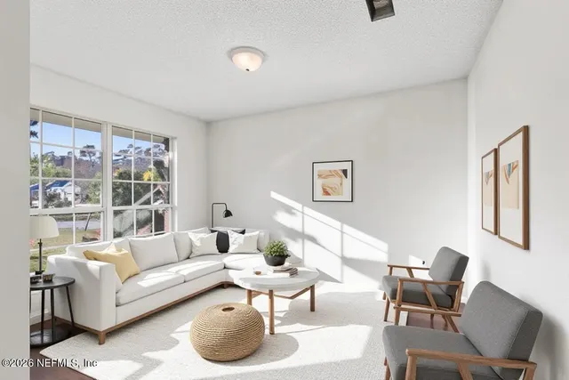 a living room with furniture and a large window