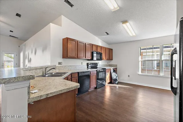 a kitchen with a stove a sink and a refrigerator