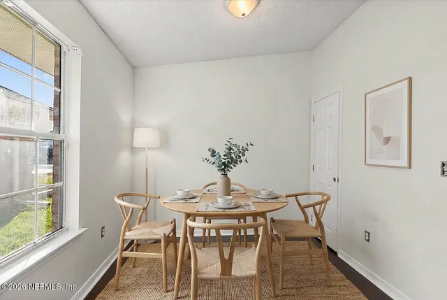 a view of a dining room with furniture and wooden floor