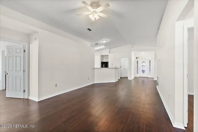 wooden floor in an empty room with a window