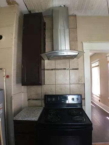 a kitchen with a stove and cabinets