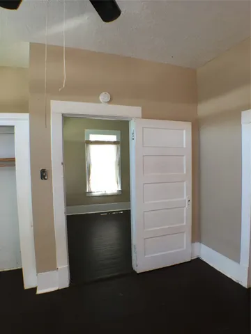 a view of a hallway with wooden floor