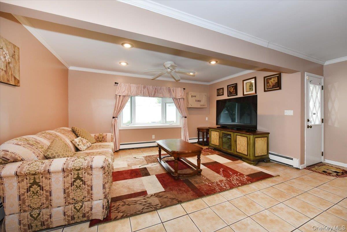 307 Blacksmith Road Levittown, NY 11756 - Photo 5 of 27 a living room with furniture and a flat screen tv