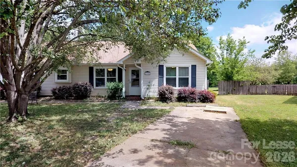 a view of a house with backyard sitting area and garden