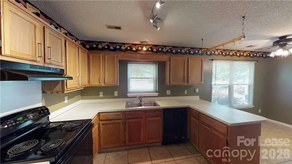 a kitchen with a sink a stove and a window