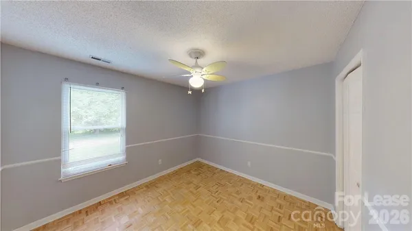 a view of a livingroom with a ceiling fan and window