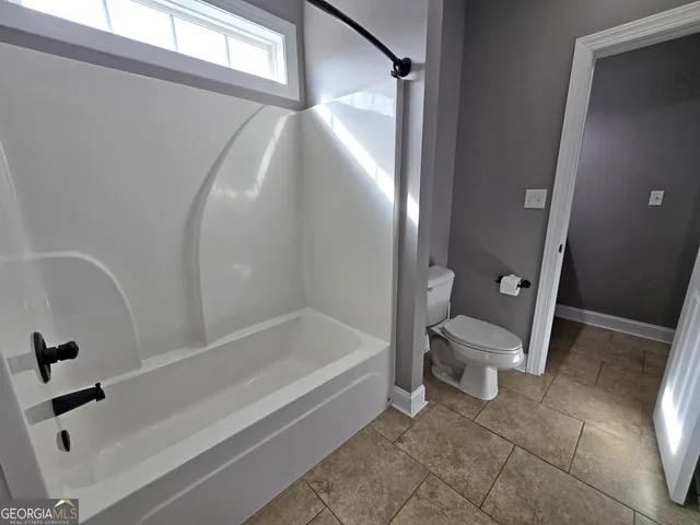 a bathroom with a sink a toilet and a bathtub