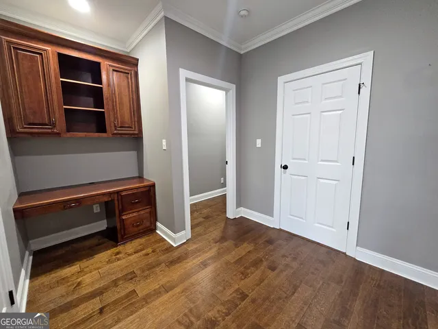 an empty room with closet and windows