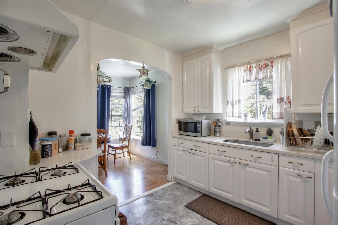 Willits Street Daly City, CA 94014 - Photo 11 of 50 a kitchen with a stove a sink and a granite counter top