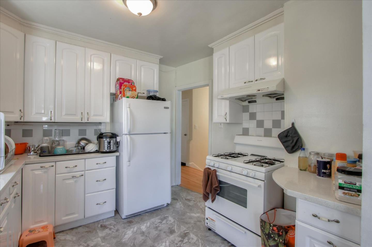 Willits Street Daly City, CA 94014 - Photo 13 of 50 a kitchen with white cabinets and appliances