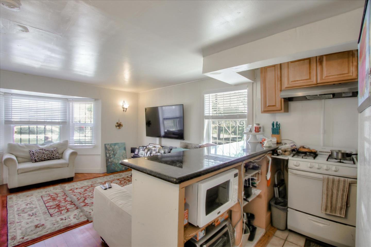 Willits Street Daly City, CA 94014 - Photo 16 of 50 a kitchen with stainless steel appliances a stove a sink dishwasher a refrigerator and cabinets with wooden floor