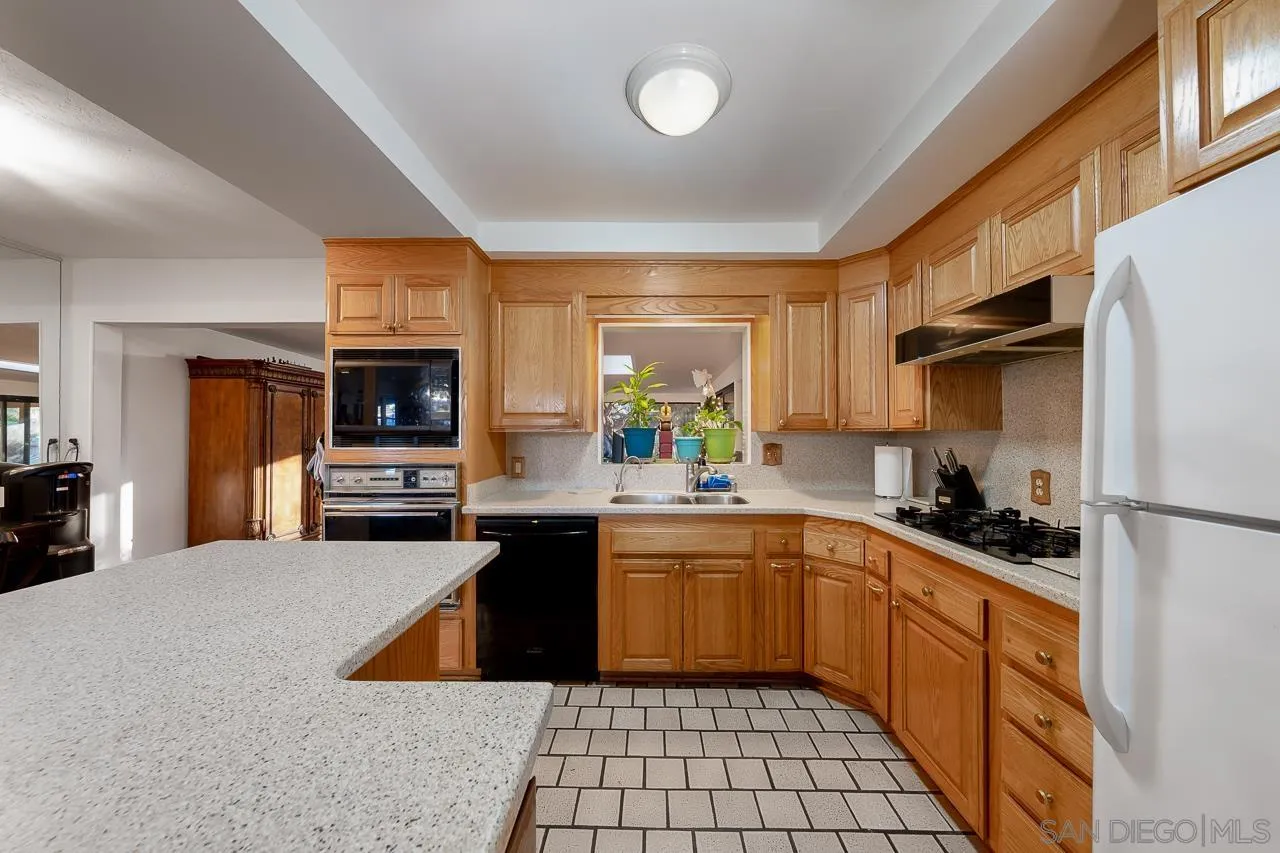 1225 Andover Road El Cajon, CA 92019 - Photo 12 of 27 a kitchen with stainless steel appliances a sink stove refrigerator and cabinets