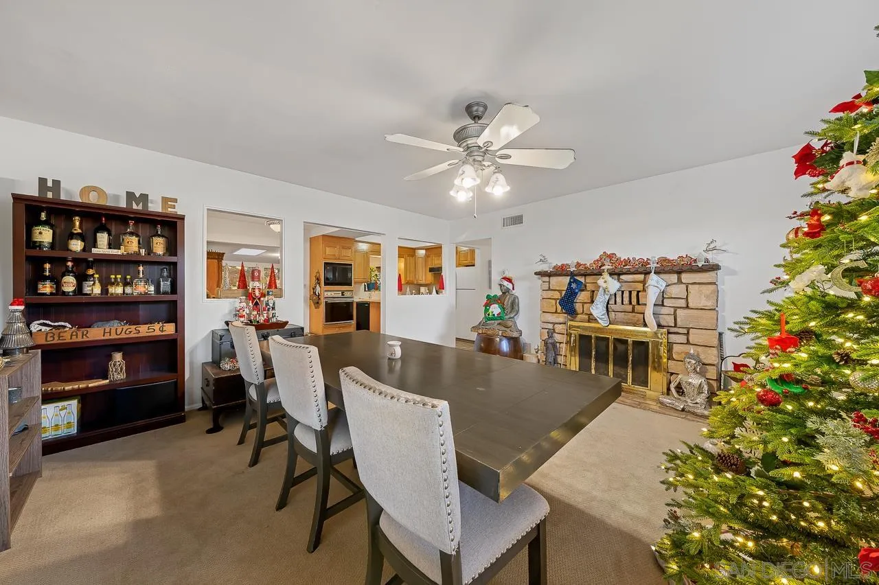 1225 Andover Road El Cajon, CA 92019 - Photo 7 of 27 a living room with furniture a bookshelf and a potted plant