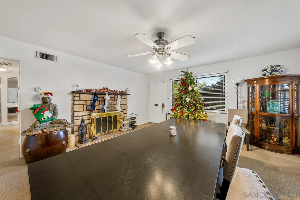 1225 Andover Road El Cajon, CA 92019 - Photo 9 of 27 a living room with fireplace furniture and a chandelier