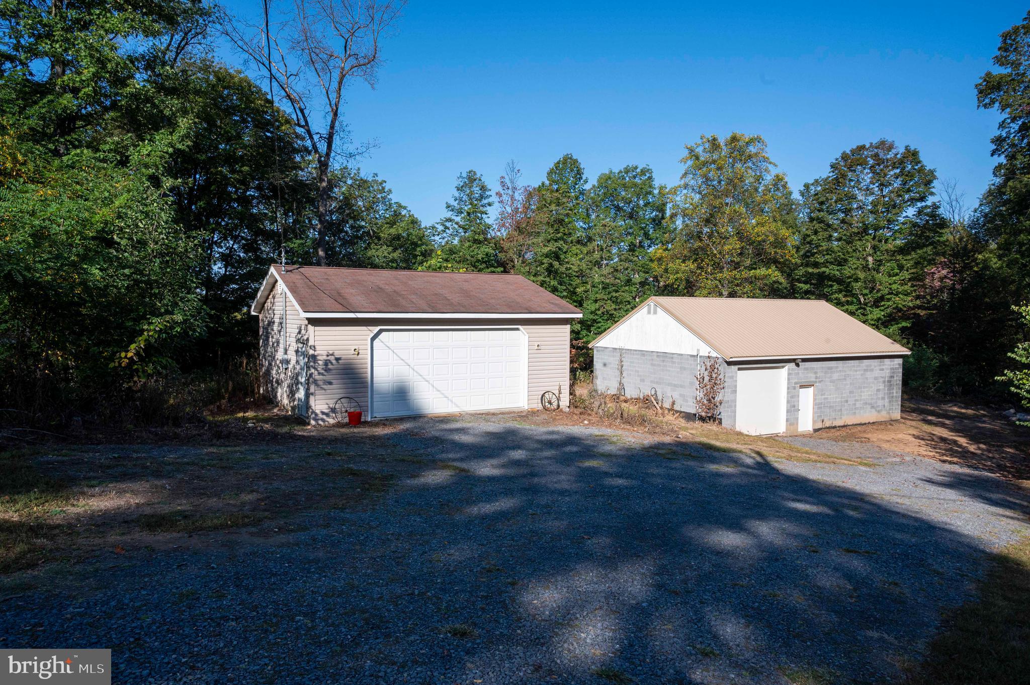 3225 Magnolia Road Great Cacapon, WV 25422 - Photo 14 of 59 a view of a house with a yard and garage