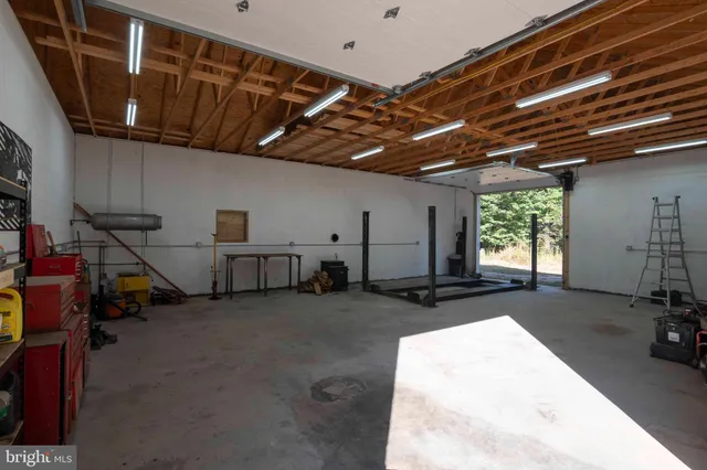 a living room with furniture and a book shelf