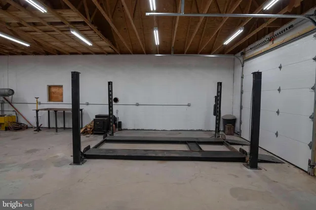 a living room with furniture a window and gym equipment