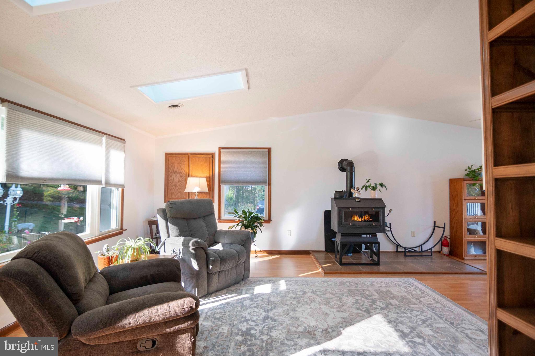 3225 Magnolia Road Great Cacapon, WV 25422 - Photo 18 of 59 a living room with furniture a window and gym equipment