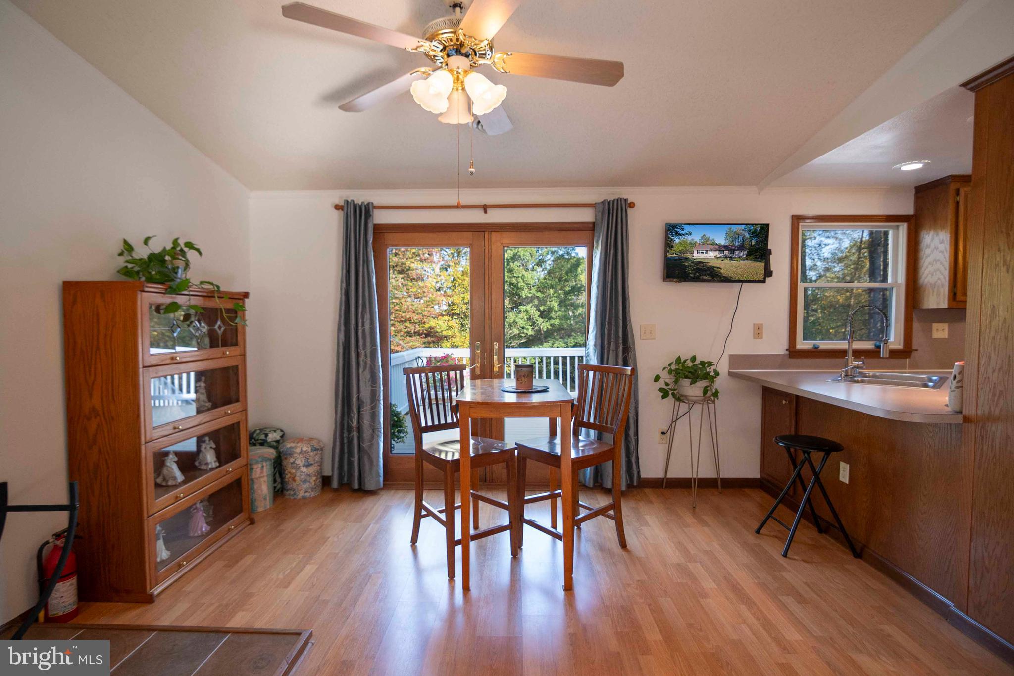 3225 Magnolia Road Great Cacapon, WV 25422 - Photo 19 of 59 a view of a dining room with furniture window and wooden floor