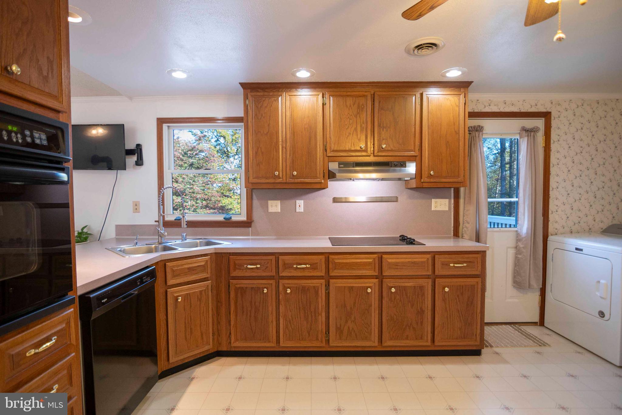 3225 Magnolia Road Great Cacapon, WV 25422 - Photo 20 of 59 a kitchen with a sink window and cabinets