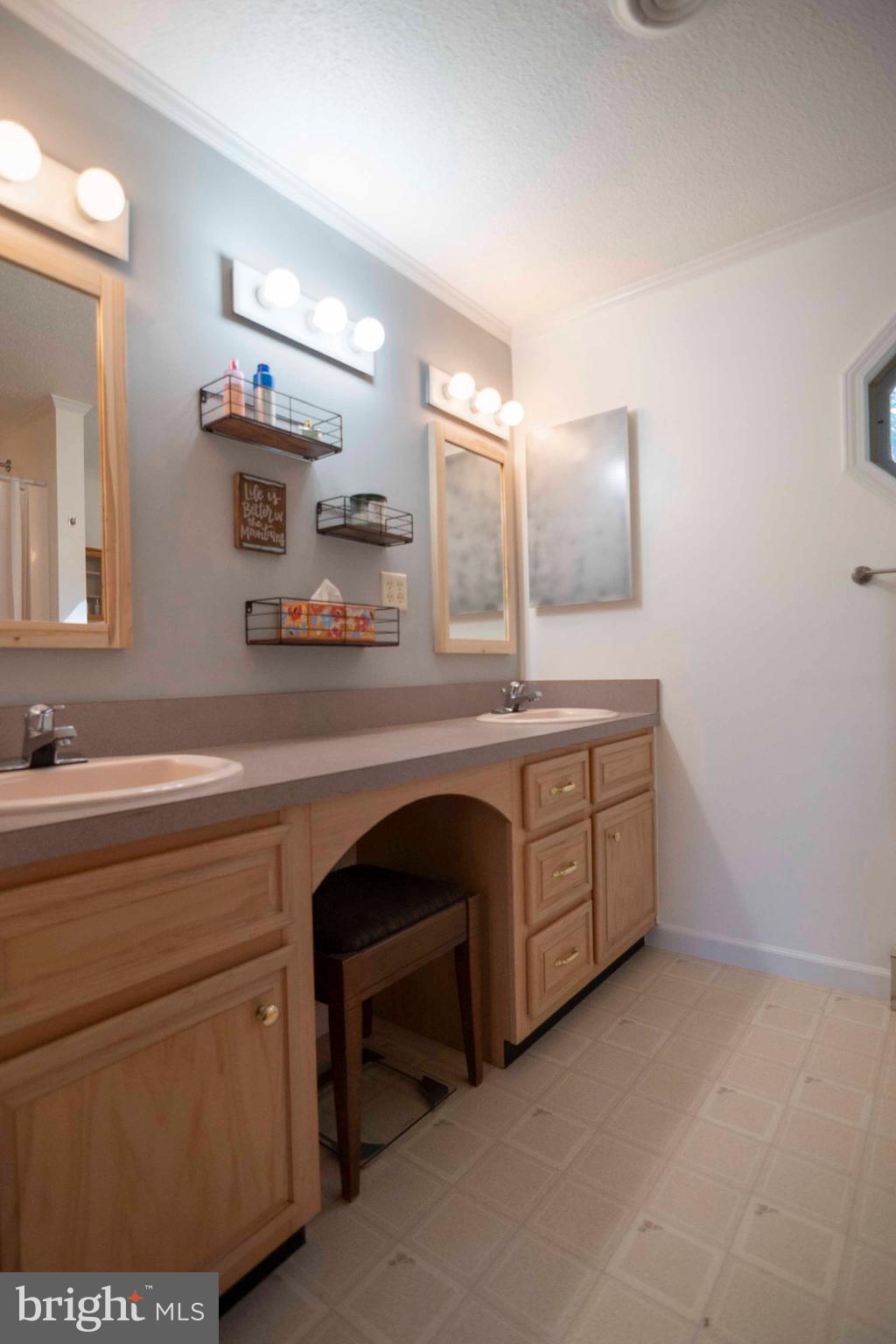 3225 Magnolia Road Great Cacapon, WV 25422 - Photo 29 of 59 a spacious bathroom with a double vanity sink a mirror and a