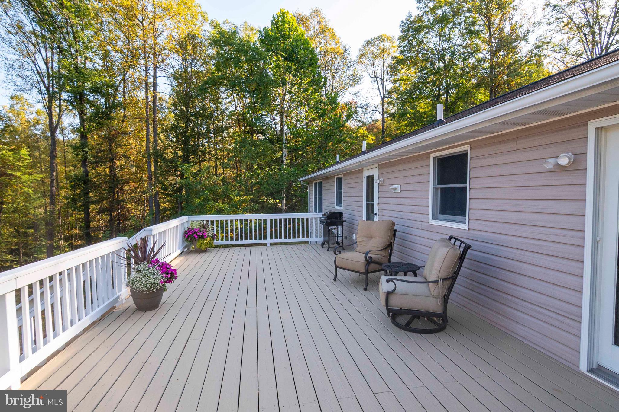 3225 Magnolia Road Great Cacapon, WV 25422 - Photo 36 of 59 a balcony with wooden floor and furniture