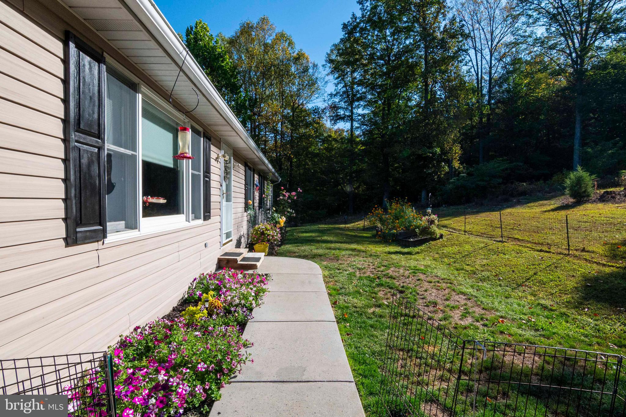 3225 Magnolia Road Great Cacapon, WV 25422 - Photo 39 of 59 a front view of a house with a yard