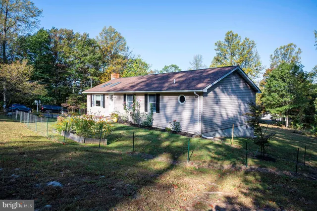 a view of house with garage and yard