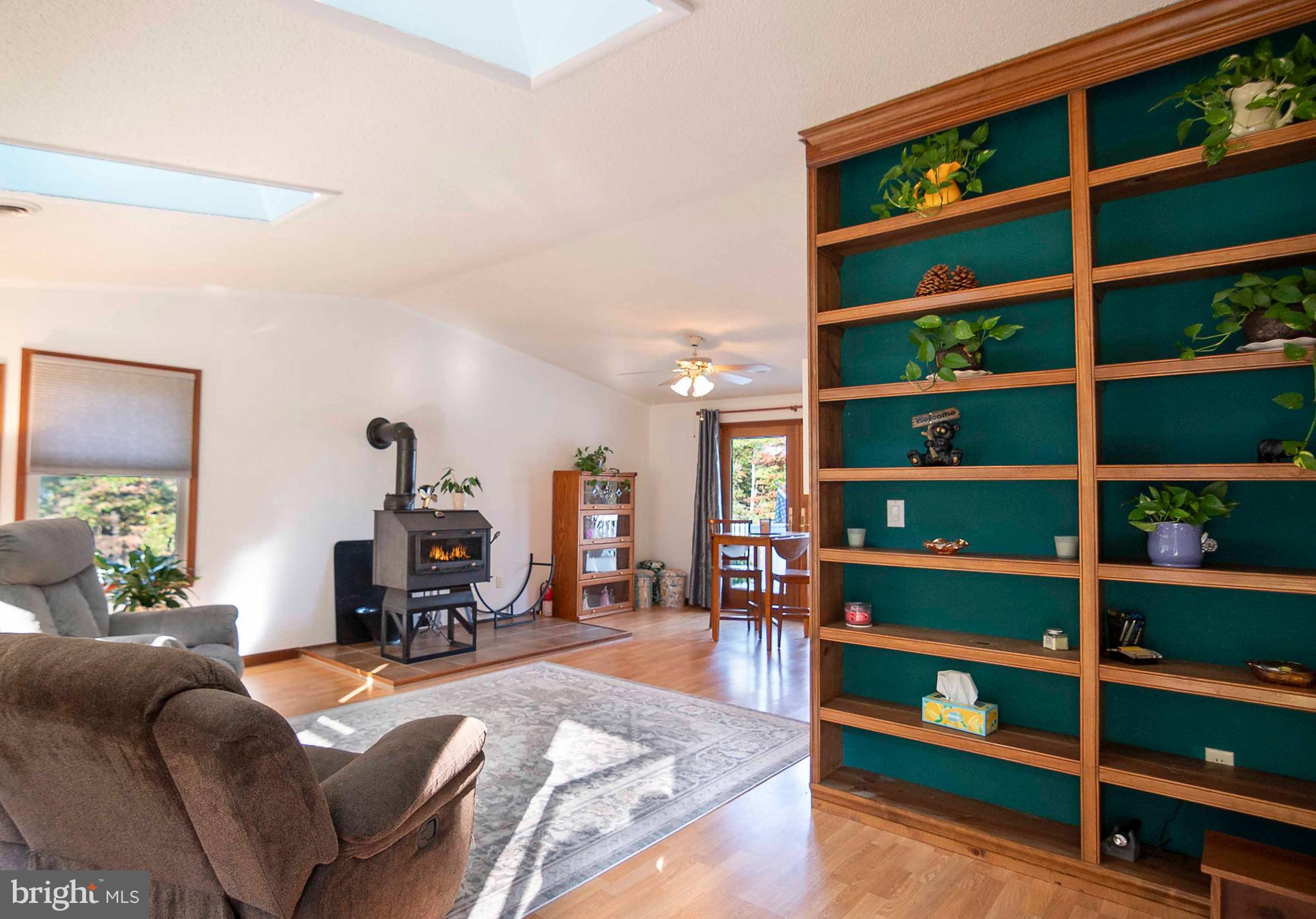 3225 Magnolia Road Great Cacapon, WV 25422 - Photo 4 of 59 a living room with furniture cabinets and a book shelf