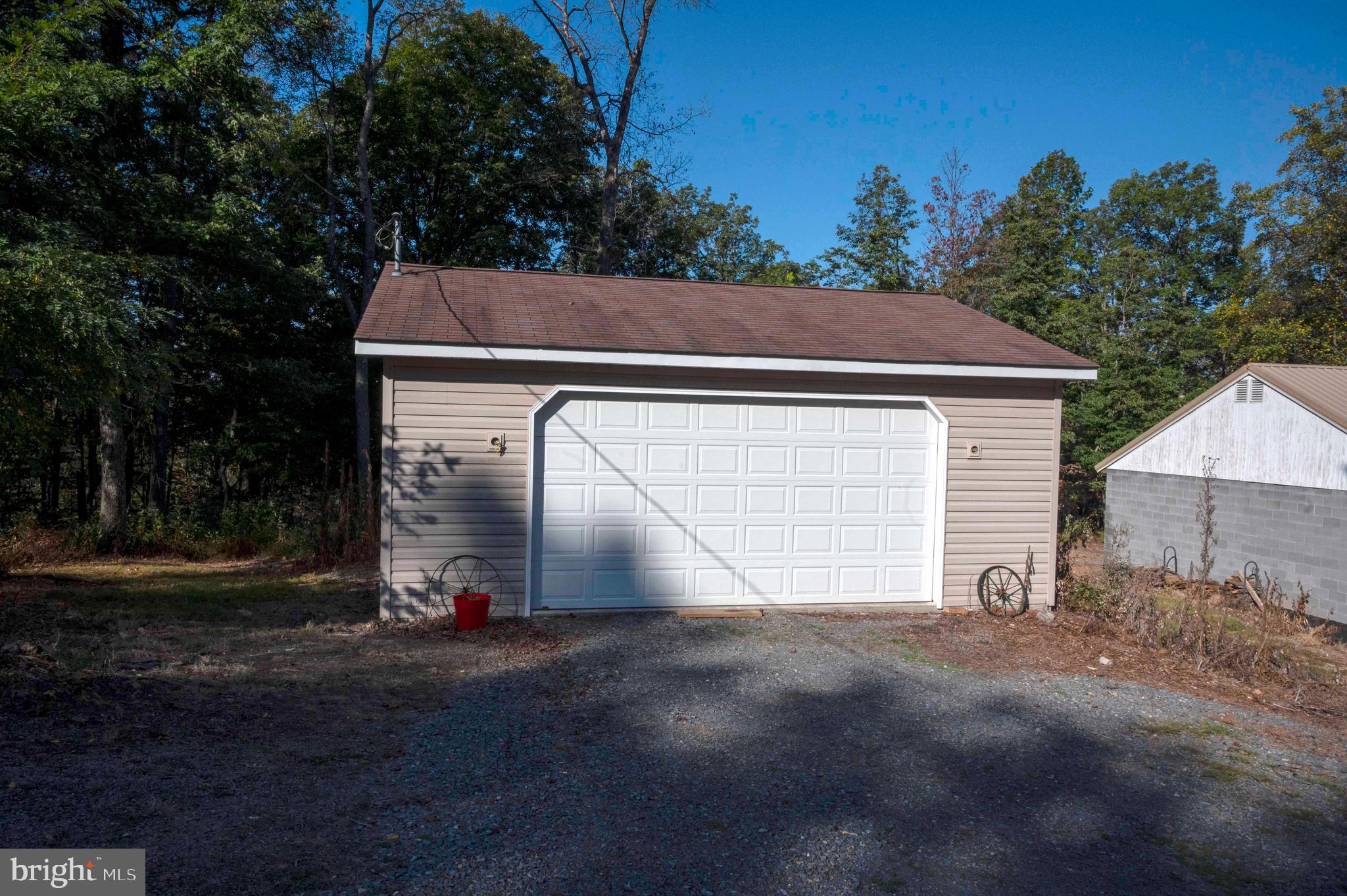 3225 Magnolia Road Great Cacapon, WV 25422 - Photo 45 of 59 a view of house with garage and yard