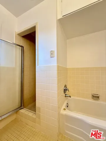 an empty room with a ceiling fan and wooden floor
