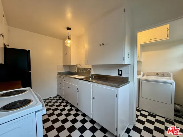 a kitchen with a sink stove and cabinets
