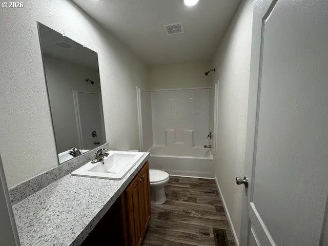 a bathroom with a double vanity sink mirror and toilet