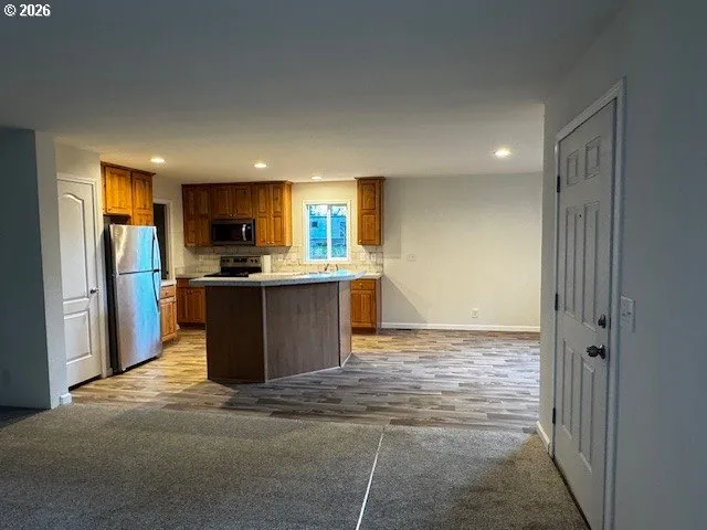 a view of a kitchen with a sink cabinets and outdoor space