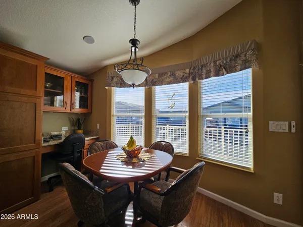 a kitchen with a table chairs and microwave