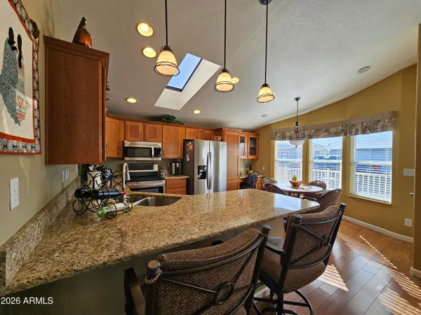 a dining room with furniture a chandelier and window