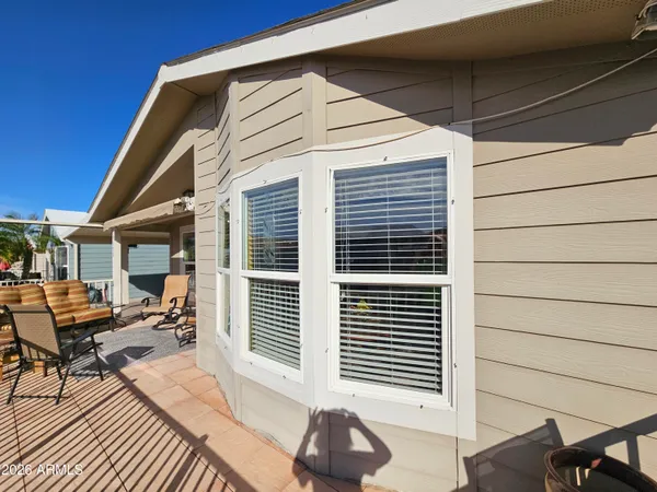 a front view of a house with sitting area