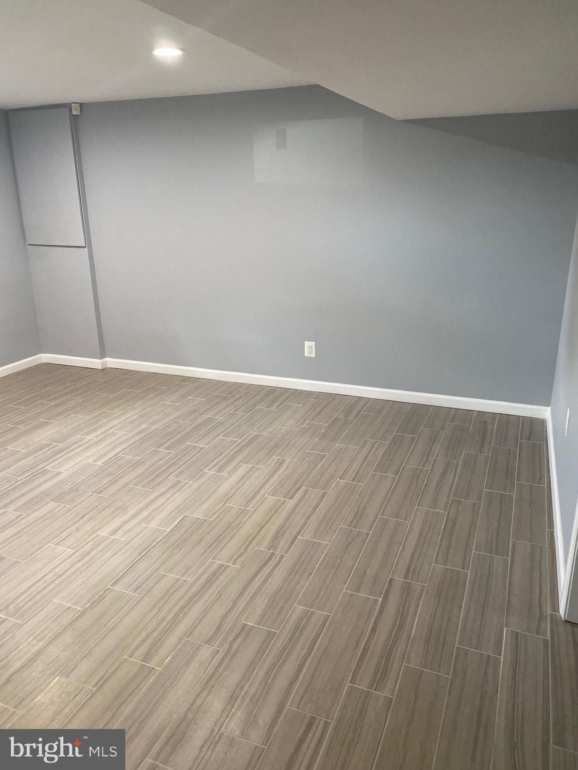 5806 Burgess Road District Heights, MD 20747 - Photo 11 of 11 a view of an empty room with wooden floor