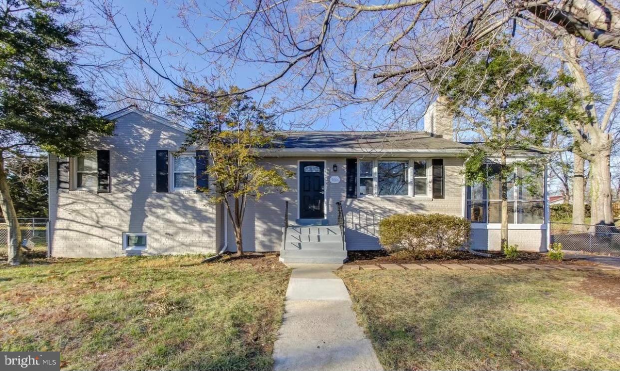5806 Burgess Road District Heights, MD 20747 - Photo 5 of 11 a front view of a house with a tree
