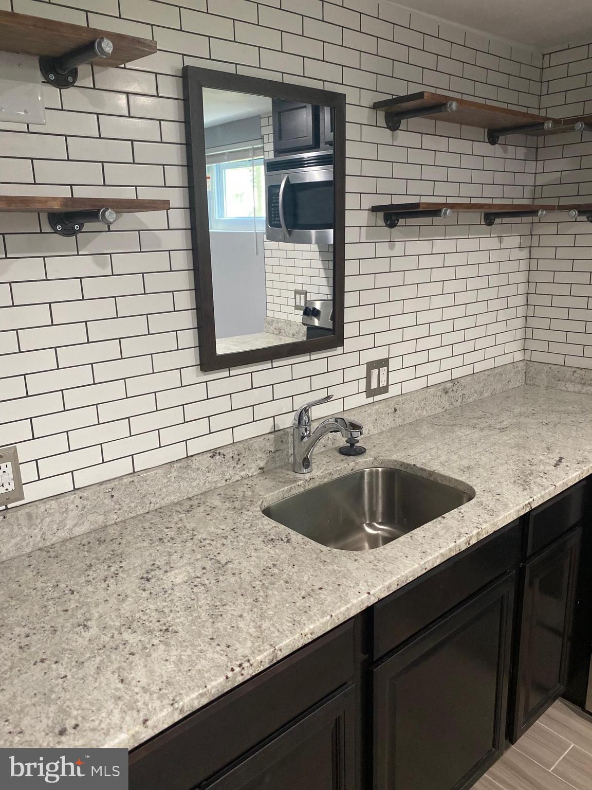 5806 Burgess Road District Heights, MD 20747 - Photo 8 of 11 a kitchen with a sink and cabinets