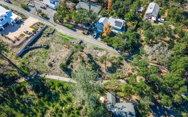 an aerial view of residential house with outdoor space and trees all around