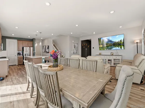 a living room with kitchen island furniture and a flat screen tv