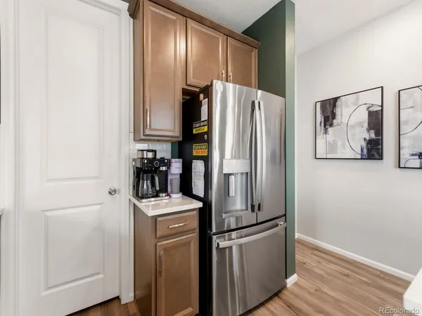 a room with refrigerator and cabinets