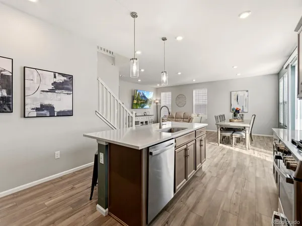 a kitchen with stainless steel appliances granite countertop a sink and a wooden floors