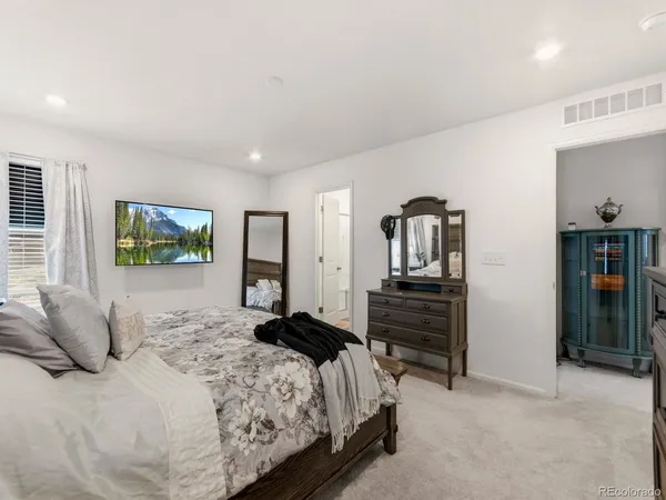 a bedroom with a bed and a dresser