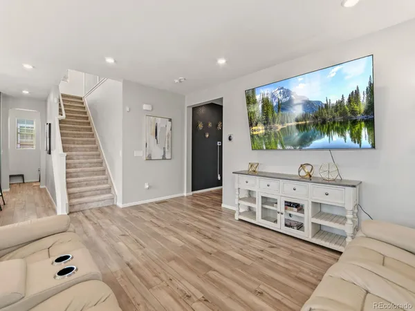 a view of a livingroom with furniture wooden floor and window